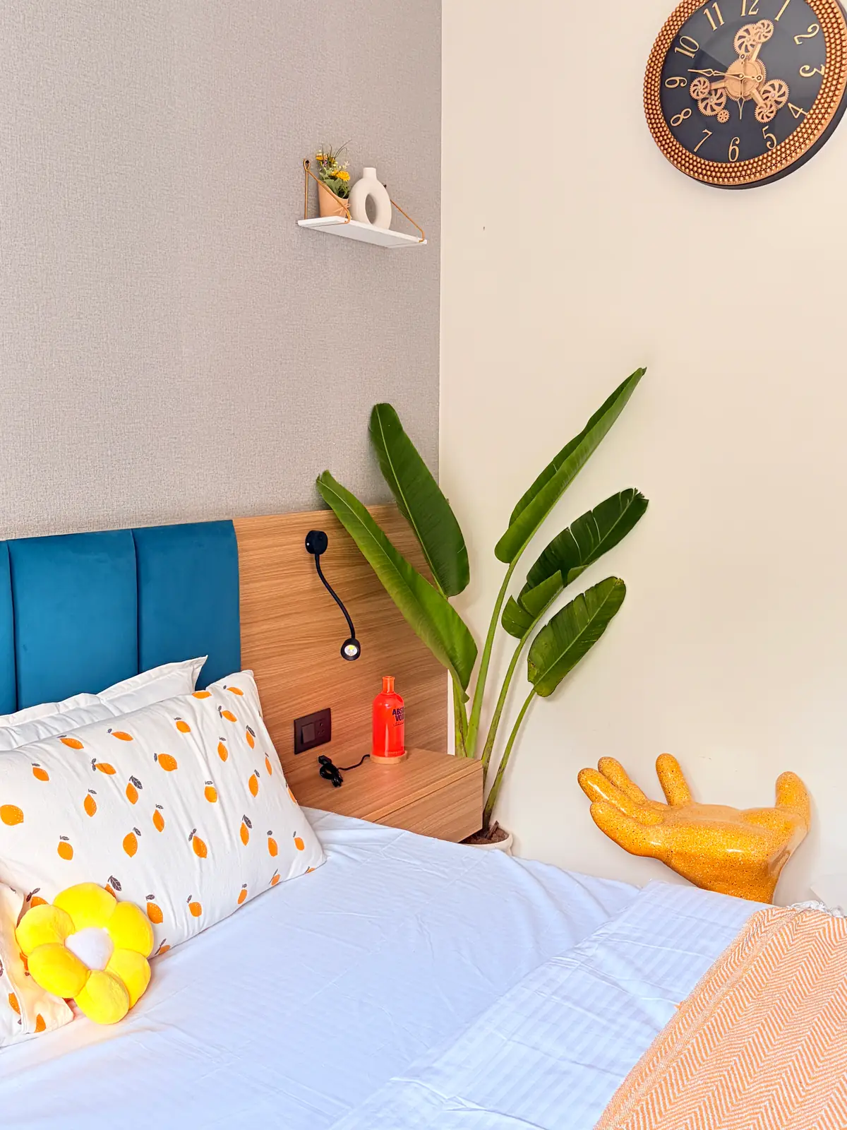 Bedroom corner with lemon-print pillows, sunflower cushion and a yellow hand chair